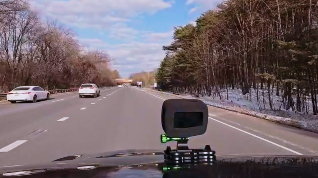 DJI Osmo Action 4 mounted on a car driving on the highway